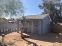 View of the outbuilding and yard showing plenty of room for gardening and other outdoor activities at 9327 E Des Moines St, Mesa, AZ 85207