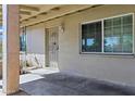 Covered front porch featuring a secure front door and ample natural light at 9522 E Quarterline Rd, Mesa, AZ 85207