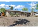 Inviting single-story home with xeriscaping and a covered porch entry at 9522 E Quarterline Rd, Mesa, AZ 85207