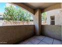 Cozy balcony view featuring an open-air space, stucco walls, and a view of mature trees at 9550 E Thunderbird Rd # 149, Scottsdale, AZ 85260