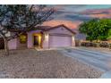 Inviting single-story home featuring desert landscaping, covered entry, and attached two-car garage at 9704 W Cordes Rd, Tolleson, AZ 85353