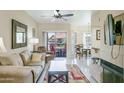 Inviting living room boasts a ceiling fan and sliding glass doors to the outdoor patio at 9711 E Mountain View Rd # 2543, Scottsdale, AZ 85258