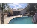 Backyard pool and covered patio, ready for entertaining or relaxation at 16002 N 23Rd Ave, Phoenix, AZ 85023