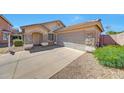 Charming home showcasing stone accents, a well-maintained yard, and an attached two-car garage at 16036 N 11Th Ave # 1084, Phoenix, AZ 85023