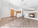 Open concept living space featuring tile flooring, a fireplace, and a ceiling fan for added comfort at 16036 N 11Th Ave # 1084, Phoenix, AZ 85023