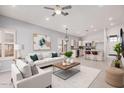 Spacious living room featuring modern decor, an open floor plan, and a ceiling fan at 1712 E Saratoga St, Gilbert, AZ 85296