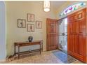 Inviting foyer area with an open front door, wood flooring, and decorative trim at 18920 N 92Nd Way, Scottsdale, AZ 85255