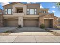 Inviting townhome with a multi-car garage, well-maintained landscaping, and stylish architectural details at 19550 N Grayhawk Dr # 1049, Scottsdale, AZ 85255