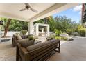 Inviting outdoor patio with comfortable seating, ceiling fan, and a relaxing garden view at 3117 E Maryland Ave, Phoenix, AZ 85016