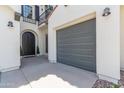Charming home featuring an arched front door, a convenient attached garage, and balcony with decorative wrought iron at 4615 E Calistoga Dr, Gilbert, AZ 85297