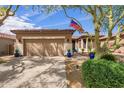 Single-story home with neutral toned facade, desert landscaping, and a two-car garage at 7256 E Desert Vista Rd, Scottsdale, AZ 85255