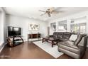 Comfortable living room with a leather sectional, ceiling fan, and modern decor at 8313 E Camelback Rd, Scottsdale, AZ 85251