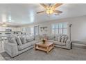 Bright living room with a large sectional and seamless flow into the adjacent kitchen area at 10417 W Pioneer St, Tolleson, AZ 85353
