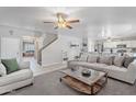 Spacious living area with neutral tones, opening to the kitchen with a view to the stairs at 10417 W Pioneer St, Tolleson, AZ 85353