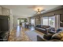 Cozy living room with tile flooring, neutral walls, and comfortable seating area at 11060 E Sorpresa Ave, Mesa, AZ 85212