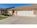Inviting front exterior of a home with a spacious driveway, neat landscaping, and a welcoming entrance at 11250 E Kilarea Ave # 276, Mesa, AZ 85209
