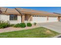 Attractive home exterior with a two-car garage, lush landscaping, and a well-maintained lawn, creating curb appeal at 11250 E Kilarea Ave # 276, Mesa, AZ 85209