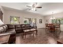 Spacious living room with hardwood floors, leather sofa, and access to outdoor patio at 15225 N 100Th St # 1209, Scottsdale, AZ 85260