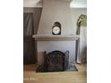 Arched fireplace with decorative screen and vintage clock on the mantel at 1629 E Garfield St, Phoenix, AZ 85006