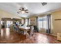Bright dining room with tile flooring, large windows, modern light fixture, and neutral wall color at 16820 N 152Nd Ln, Surprise, AZ 85374