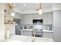 Contemporary kitchen featuring stainless steel appliances, modern cabinetry, and quartz countertops at 1701 E Colter St # 488, Phoenix, AZ 85016