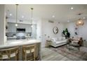 Cozy living room with a modern kitchen and island, complete with a comfortable sofa and stylish decor at 1701 E Colter St # 488, Phoenix, AZ 85016