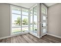 Light-filled foyer with large windows, stylish front door, and attractive wood-look vinyl plank flooring at 1920 N Cavalier Dr, Tempe, AZ 85288