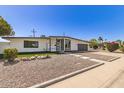 Charming single-story home with a well-manicured front yard, desert landscaping, and blue sky at 1920 N Cavalier Dr, Tempe, AZ 85288