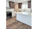 Modern kitchen features stainless steel appliances, quartz countertops, and an island at 1920 N Cavalier Dr, Tempe, AZ 85288