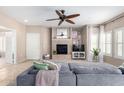 Cozy living room featuring a fireplace, ceiling fan, and sliding glass doors to the patio at 19700 N 76Th St # 1151, Scottsdale, AZ 85255
