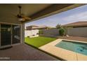Private backyard with a covered patio, swimming pool, and lush landscaping for outdoor enjoyment at 20233 E Maya Rd, Queen Creek, AZ 85142