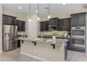 Modern kitchen with granite countertops, stainless steel appliances, and a large center island at 20233 E Maya Rd, Queen Creek, AZ 85142