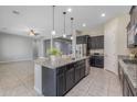 Stylish kitchen with a center island, stainless steel appliances, and ample cabinet space at 20233 E Maya Rd, Queen Creek, AZ 85142