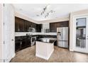 Stylish kitchen with dark wood cabinets, stainless steel appliances, granite countertops, and center island at 2090 S Dorsey Ln # 1037, Tempe, AZ 85282