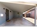 Covered carport area with direct access to the home's entrance, offering convenience and protection from the elements at 2325 E Delgado St, Phoenix, AZ 85022