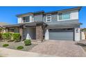 Lovely two-story home with gray colors, stone accents, front porch, and two car garage at 25725 S 230Th St, Queen Creek, AZ 85142