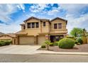 Spacious two-story home with a three-car garage and desert landscaping offers both beauty and functionality at 26926 N 55Th Ln, Phoenix, AZ 85083