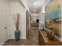 Bright hallway featuring stylish barn doors, tiled floors, and decorative accents at 2823 E Charlotte Dr, Phoenix, AZ 85024