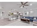 Bright, open living space featuring a modern kitchen, dining area and a comfortable blue sofa at 3323 N 28Th St, Phoenix, AZ 85016