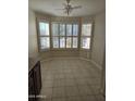 Sunlit breakfast nook featuring bay windows with plantation shutters and neutral tile flooring at 3454 E Bellerive Pl, Chandler, AZ 85249
