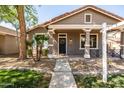 Inviting front porch with decorative columns and a cozy seating area, perfect for relaxing and enjoying the outdoors at 3756 E Waite Ln, Gilbert, AZ 85295