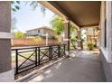 Covered front porch featuring sturdy columns and a black railing, offering a comfortable outdoor space at 3756 E Waite Ln, Gilbert, AZ 85295