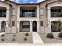 Charming townhome featuring a welcoming front porch and balcony, enhancing curb appeal at 4073 E Amoroso Dr, Gilbert, AZ 85296