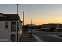 Scenic street view with mountain backdrop in a modern community at sunrise or sunset at 4073 E Amoroso Dr, Gilbert, AZ 85296
