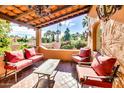 Inviting outdoor patio with comfortable seating, brick flooring, and beautiful views of the surrounding landscape at 4203 E Hazelwood St, Phoenix, AZ 85018