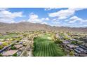 Expansive aerial view showcasing the community, golf course, and stunning mountain backdrop at 42109 N Astoria Way, Anthem, AZ 85086