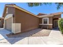 The front of the house shows great curb appeal and a bench on the front porch area at 44899 W Portabello Rd, Maricopa, AZ 85139