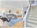 Bright living room featuring a comfortable sofa, stylish decor, and staircase to the upper level at 4620 N 68Th St # 166, Scottsdale, AZ 85251