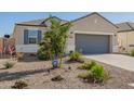 Inviting single-story home with a two-car garage, desert landscaping, and ample curb appeal at 5079 E Emery Rd, San Tan Valley, AZ 85143