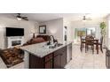 Open-concept kitchen with a view of the living room fireplace and dining area at 5079 E Emery Rd, San Tan Valley, AZ 85143